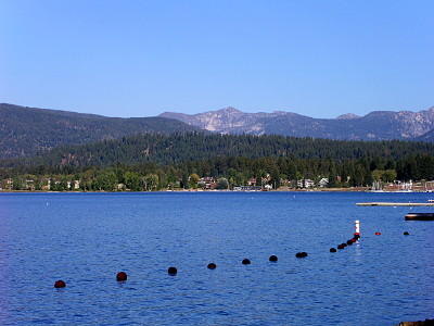 [A look across the lake shows the bouys marking the swim area and the mountains on the east side of the lake visible in the background.]